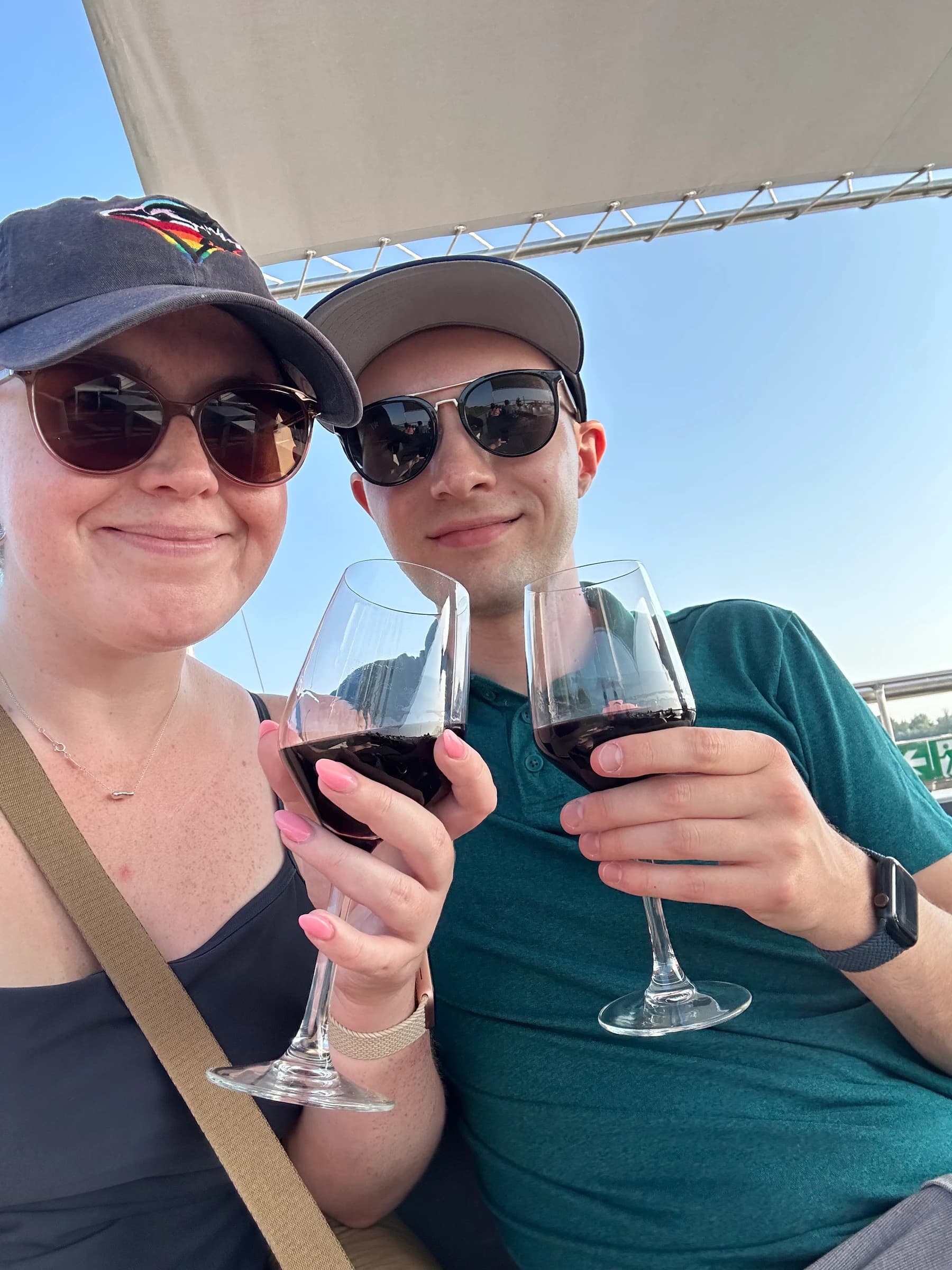 Rachel and Reid raising glasses of red wine