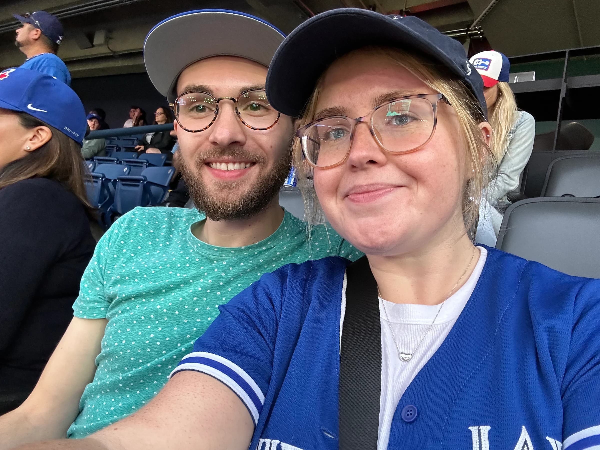 Rachel in a Blue Jays jersey with Reid in the stands at the Rogers Centre